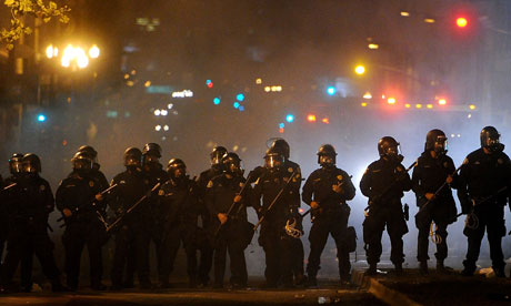 Police used teargas to drive back protesters following an attempt by the Occupy supporters to shut down the city of Oakland. Photograph: Noah Berger/AP