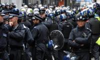 Police officers in Soho, central London, where G8 protesters with banners were believed to be occupying a former police station. Photograph: John Stillwell/PA