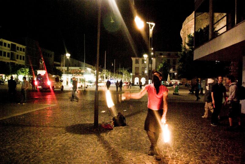 Fire juggler at night demo in Mainz, Germany.